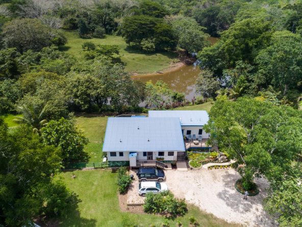 Aerial view of the 2.08-acre property in Cayo, Belize, showcasing the main house and lush landscaping